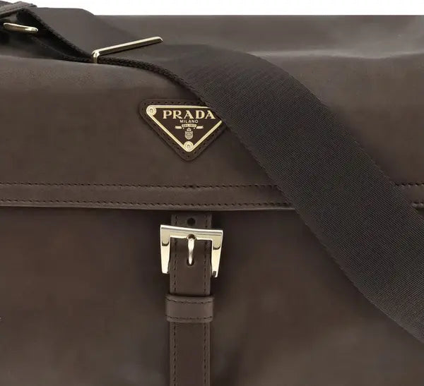 Brown Prada bag with a visible logo on a dark background