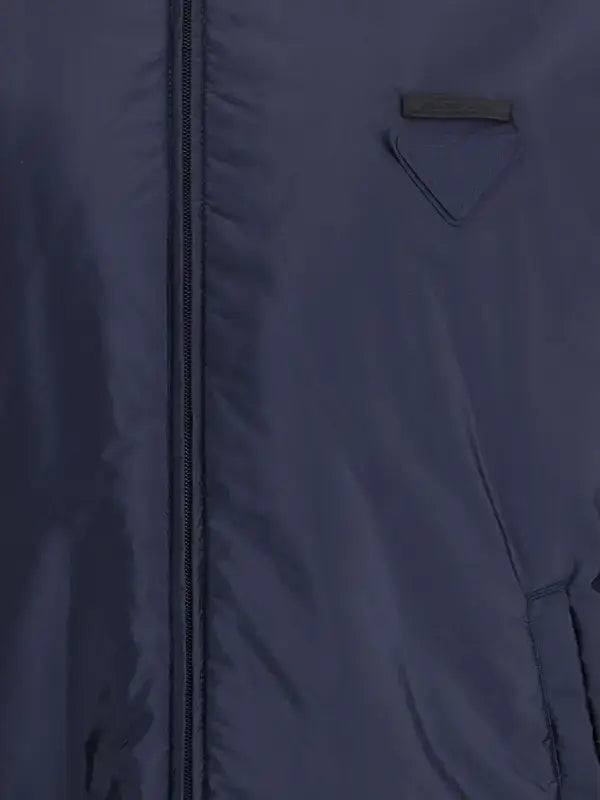 Close-up of a blue jacket with a zipper and pocket detail.