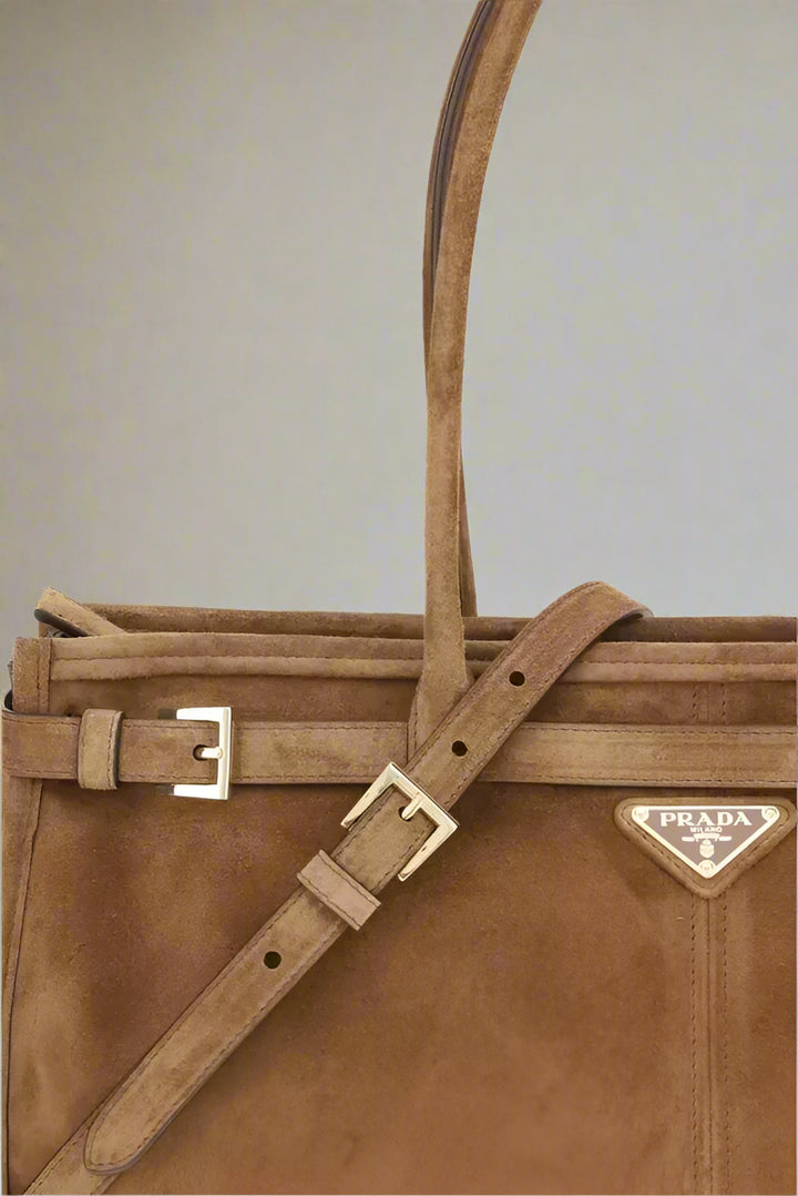 Brown Prada handbag with a strap on a white background