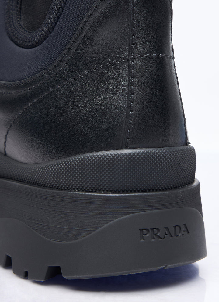 Close-up of a black Prada boot sole on a white background