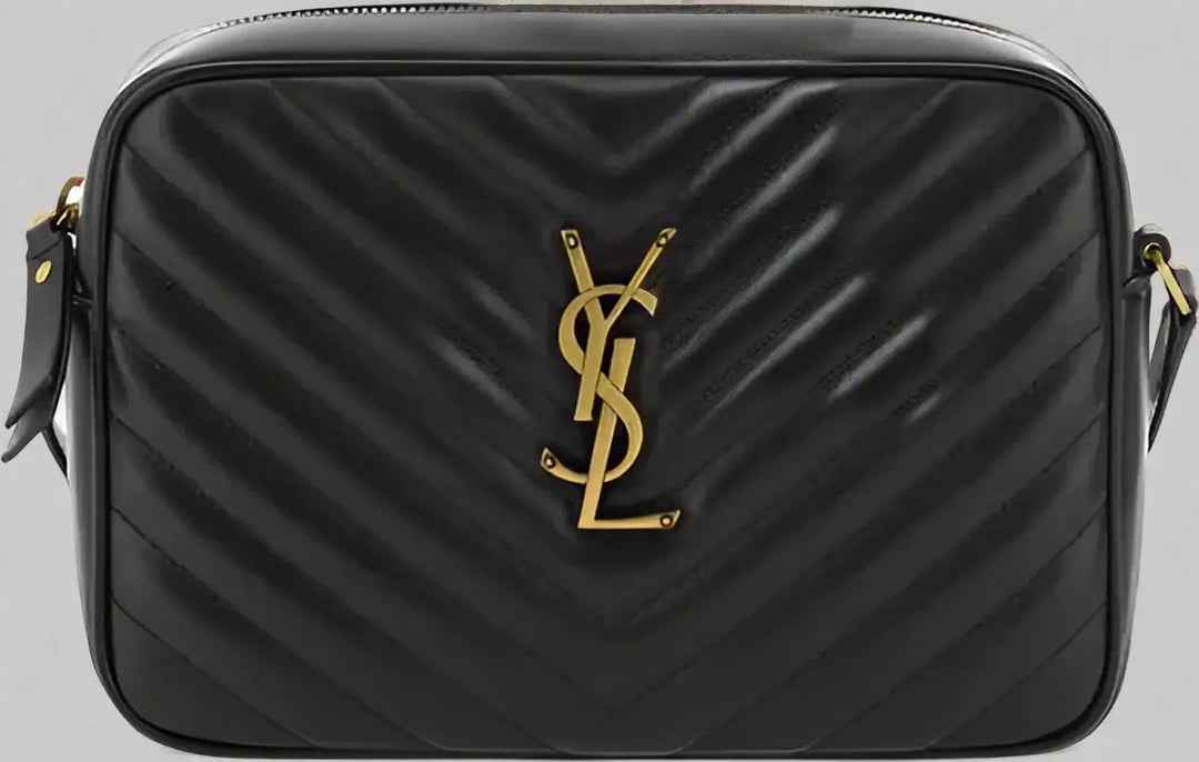 Black quilted handbag with gold logo on a white background