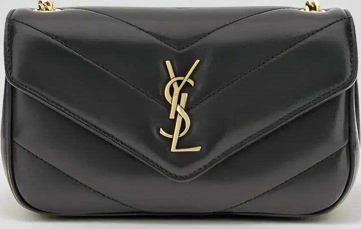 Black handbag with a gold logo on a black background