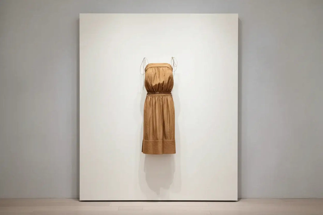 Brown strapless dress with a belt on a white background