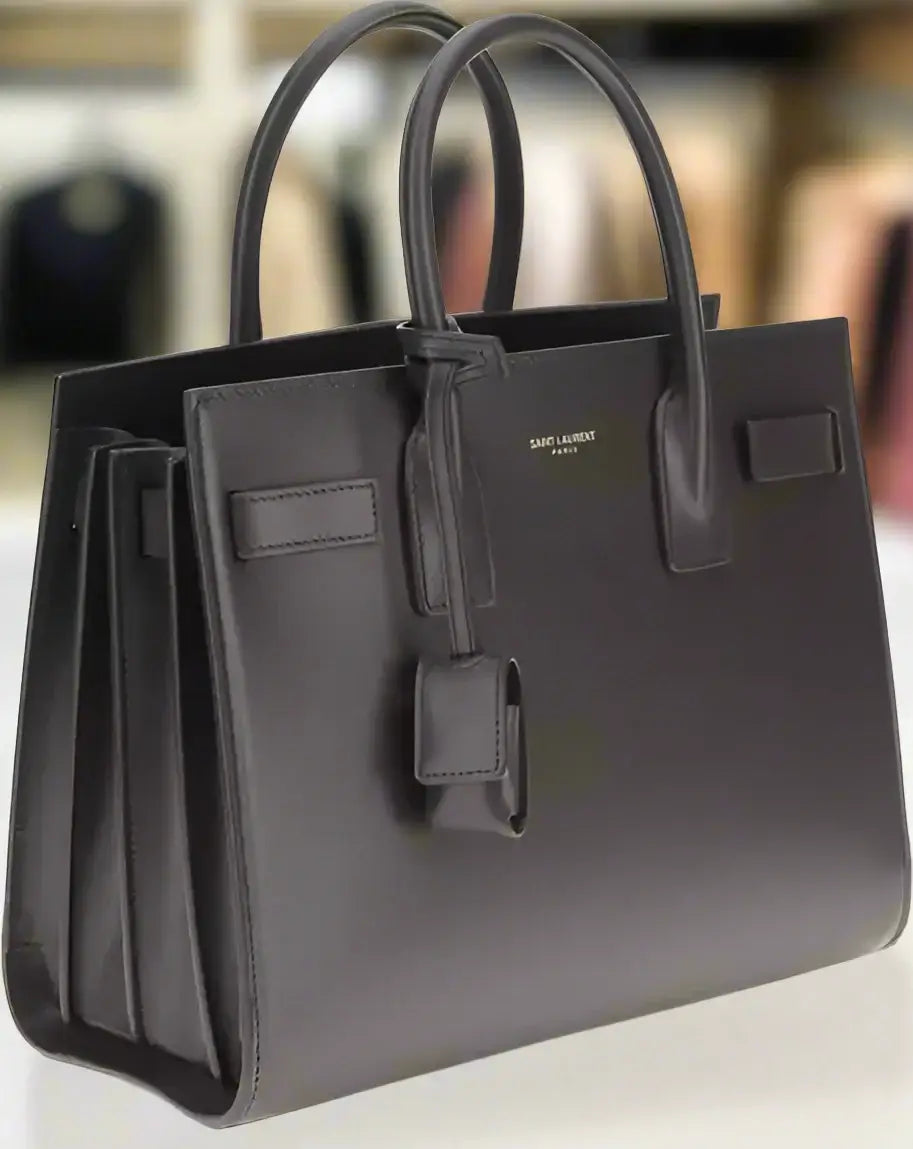 Black handbag with visible brand logo on a white background