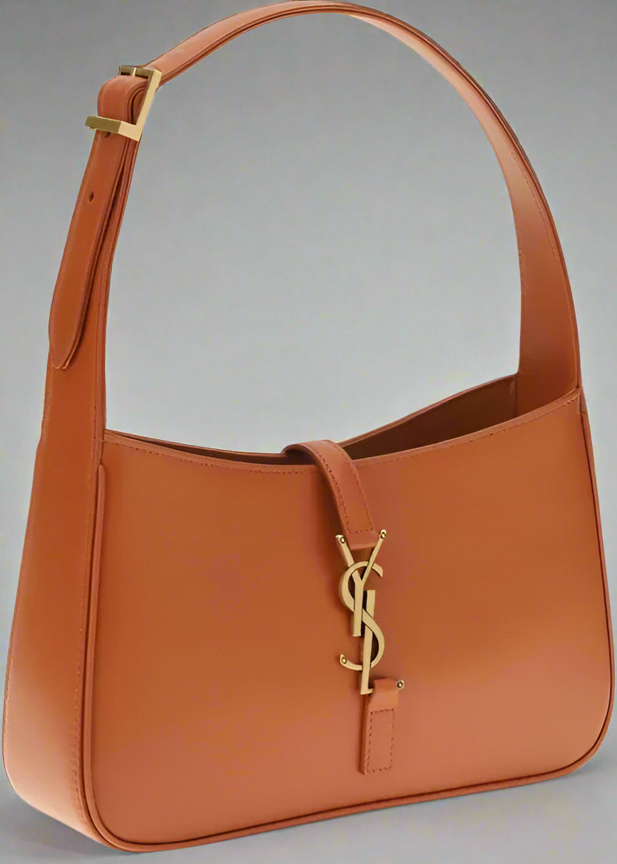 Brown leather handbag with a gold logo on a white background