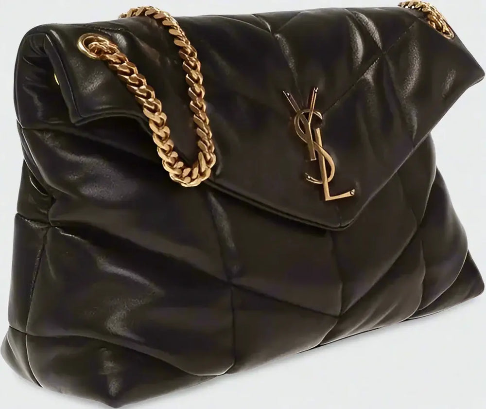 Black quilted handbag with gold chain and YSL logo on a white background