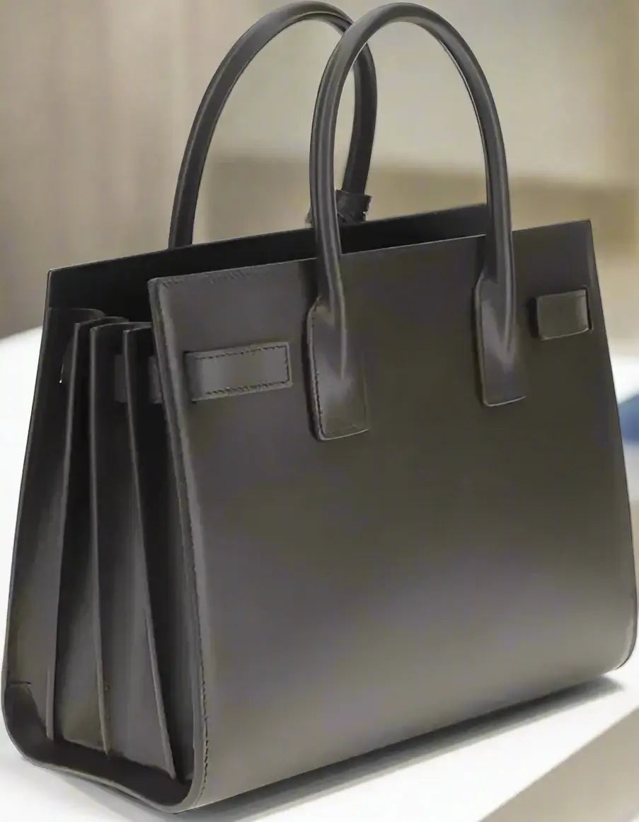 Black leather tote bag on a white background