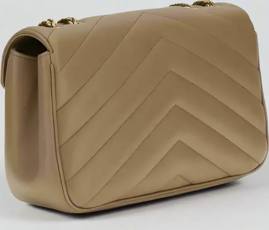 Beige handbag with chevron pattern on a white background