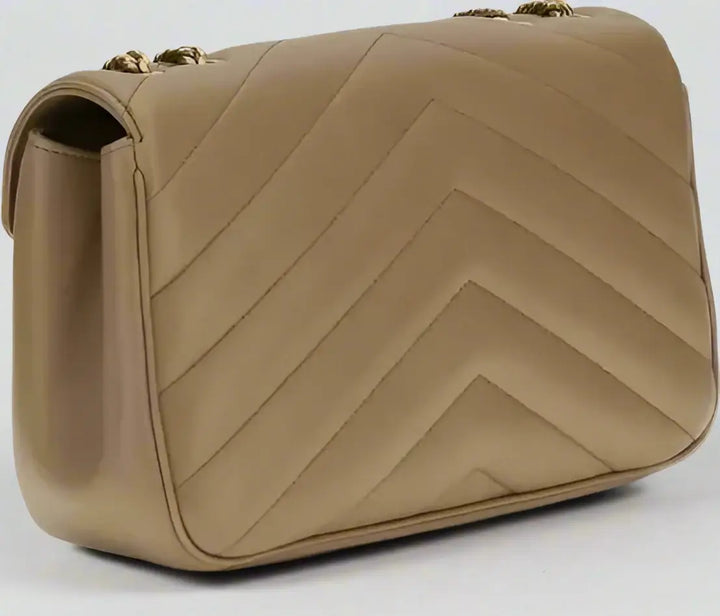 Beige handbag with chevron pattern on a white background