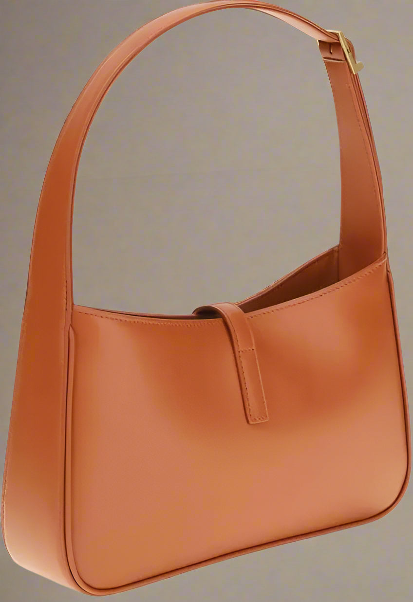 Brown leather handbag on a white background