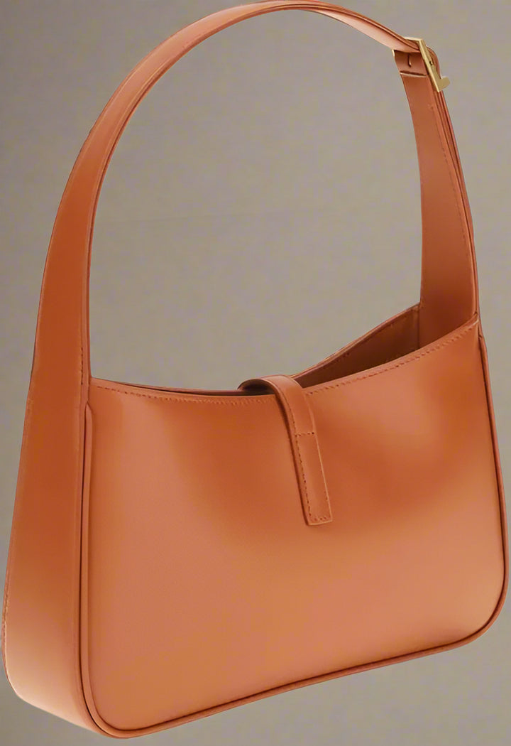 Brown leather handbag on a white background