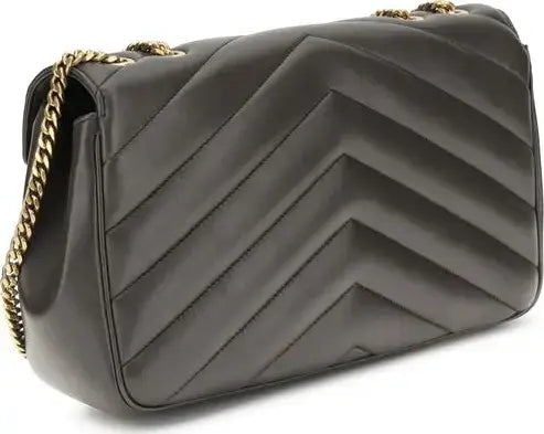 Black quilted handbag with gold chain strap on a white background