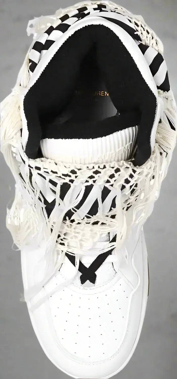 White sneaker with black accents on a white background