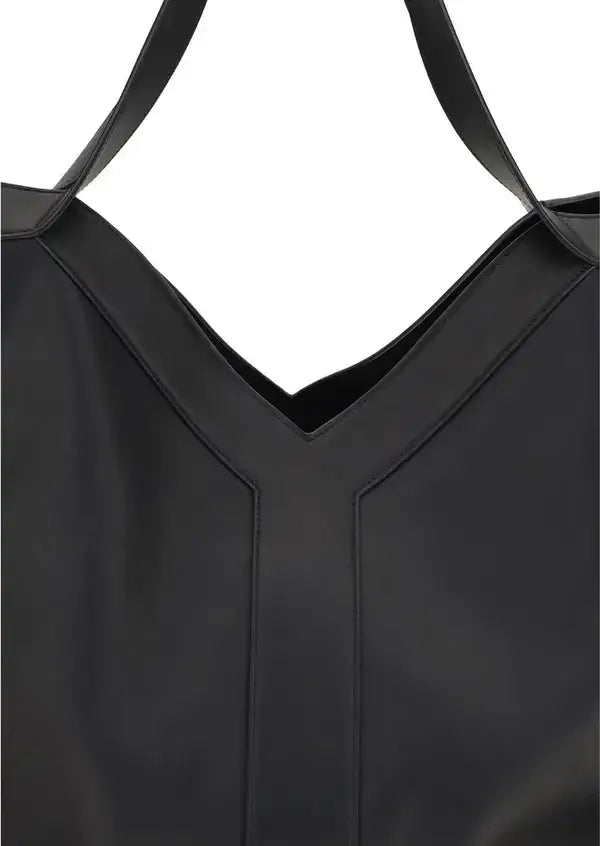 Close-up of a black dress with thin straps on a white background