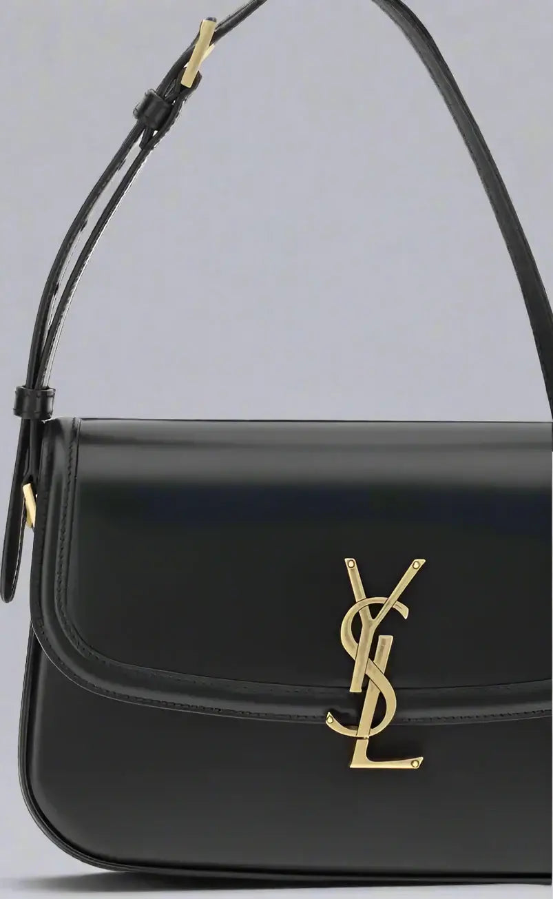 Black handbag with gold logo on a white background