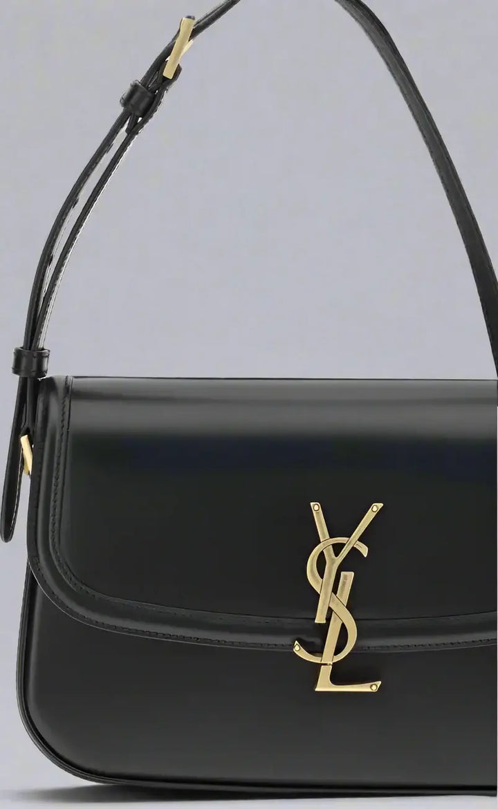 Black handbag with gold logo on a white background