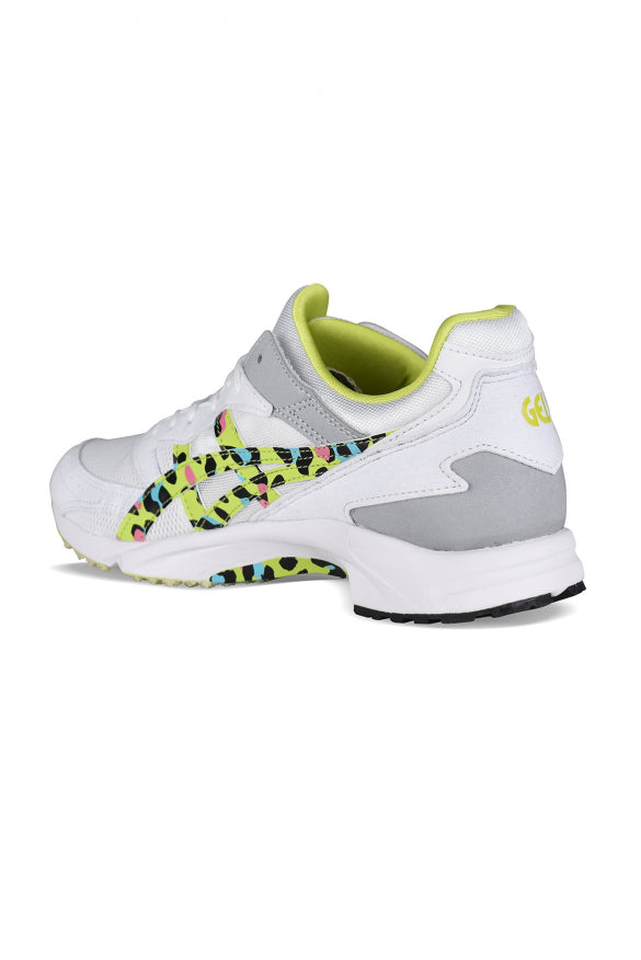 White sneaker with colorful sole design on a white background