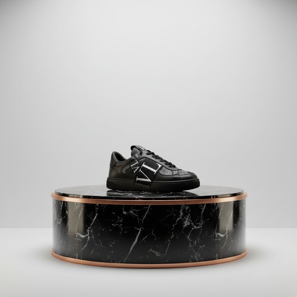 Black sneaker with 'VL' logo on a white background