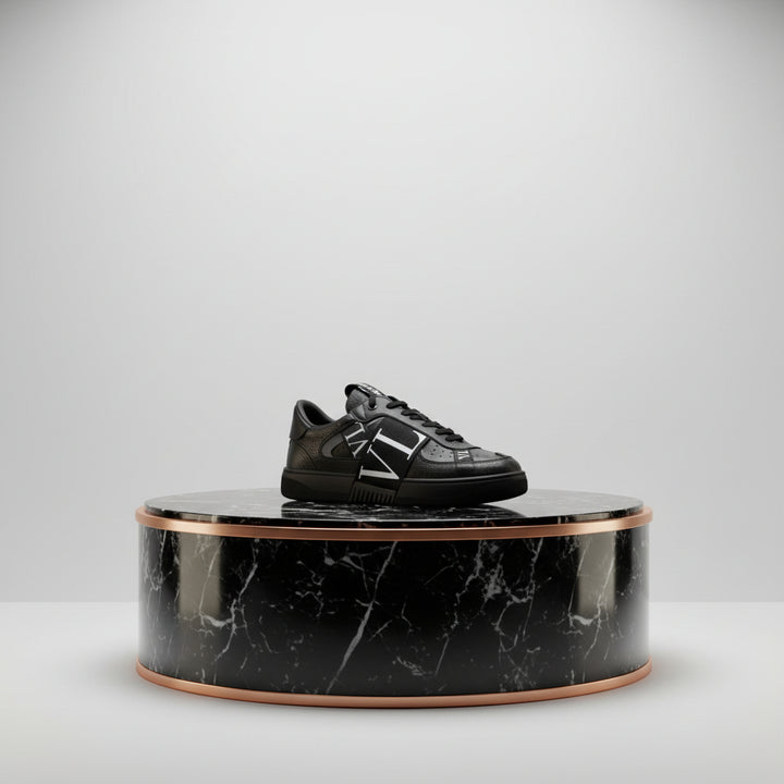 Black sneaker with 'VL' logo on a white background