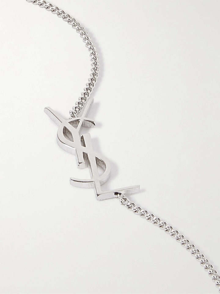 Silver chain necklace with a Yves Saint Laurent logo on a white background