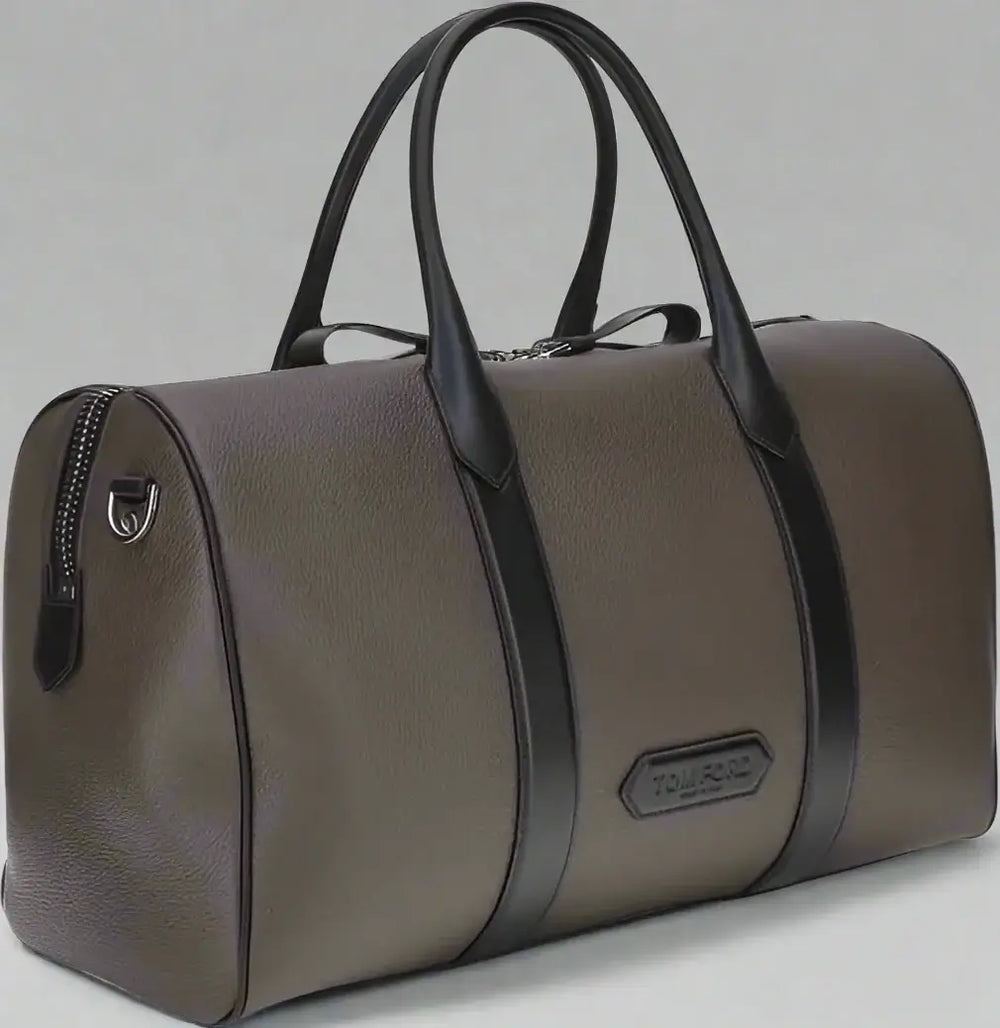 Brown duffel bag with black straps on a white background