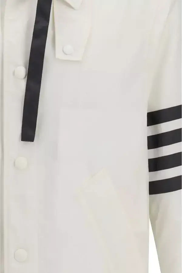 Close-up of a white jacket with black accents and buttons.
