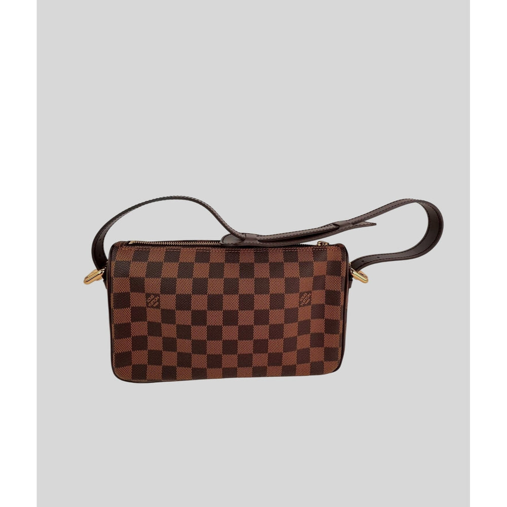 Brown checkered handbag with a strap on a light gray background