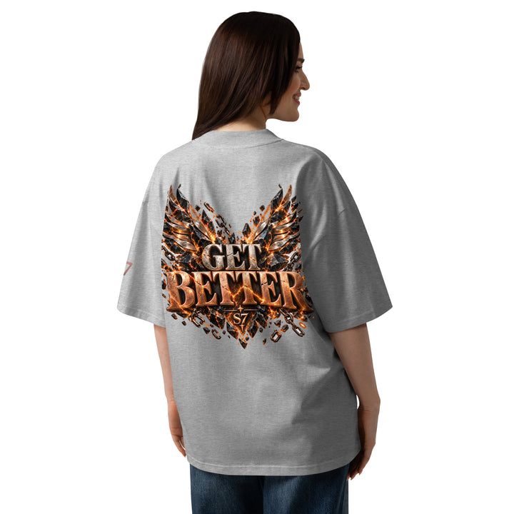 Back view of a woman wearing the DON’T GET EVEN—GET BETTER Transformation T-Shirt | S7, featuring bold copper lettering.