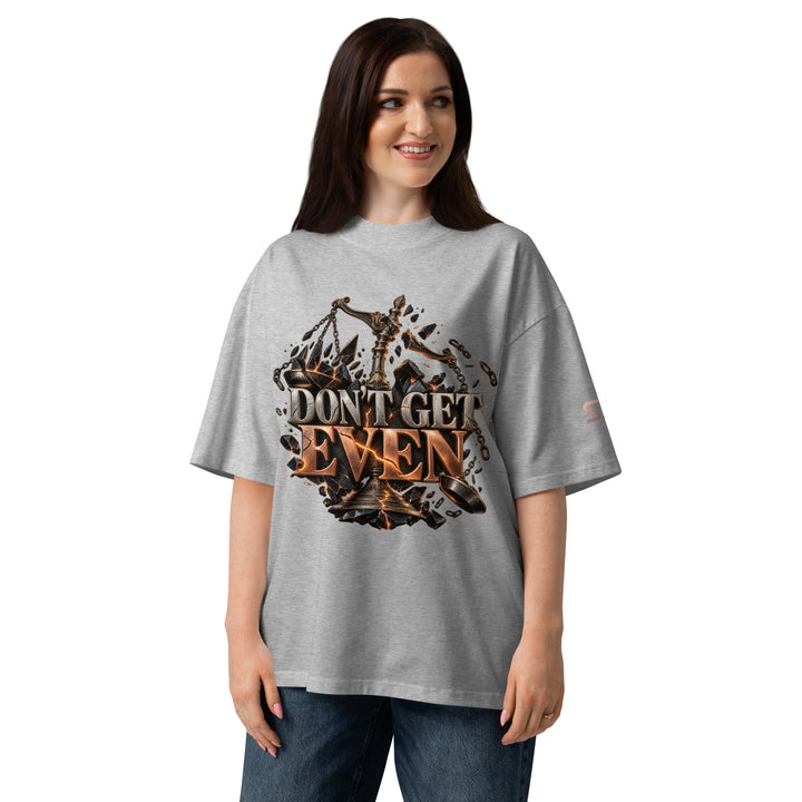 Model wearing DON’T GET EVEN—GET BETTER Transformation T-Shirt | S7 in grey, showing bold lettering and design.