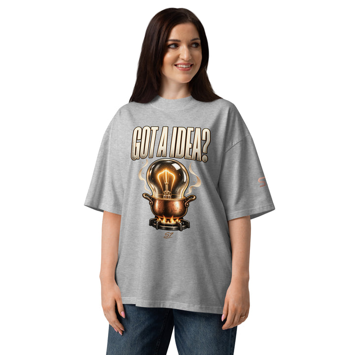 S7 “Got A Idea? Let It Cook” Graphic T-Shirt showcased on a smiling model with a bulb in a copper pot design.