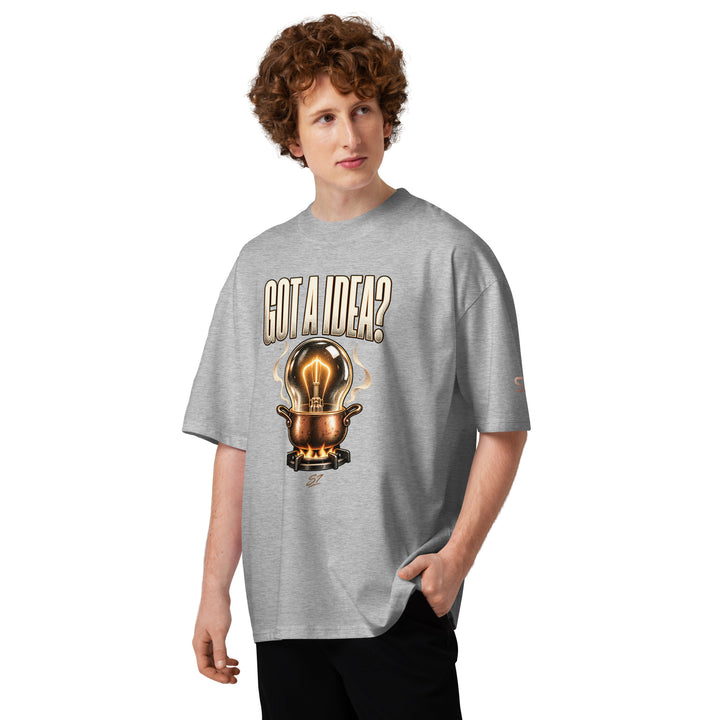 S7 “Got A Idea? Let It Cook” Graphic T-Shirt featuring light bulb design in a copper pot, modeled by a male in gray.