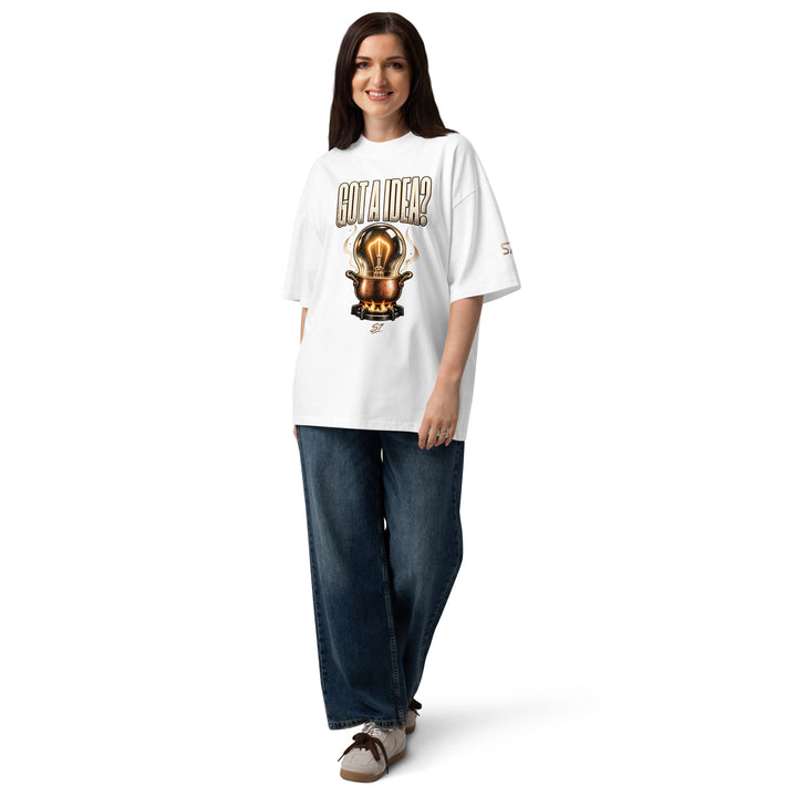 S7 “Got A Idea? Let It Cook” Graphic T-Shirt worn by a smiling woman, featuring a glowing bulb in a copper pot design.