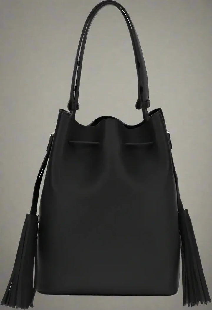 Black leather bucket bag with tassels on a white background
