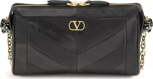 Black handbag with gold accents on a white background