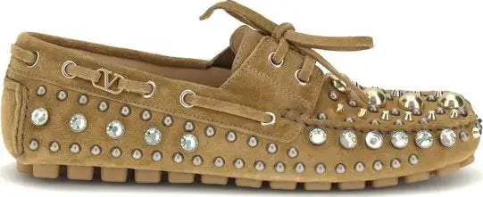 Tan loafers with rhinestone embellishments on a white background