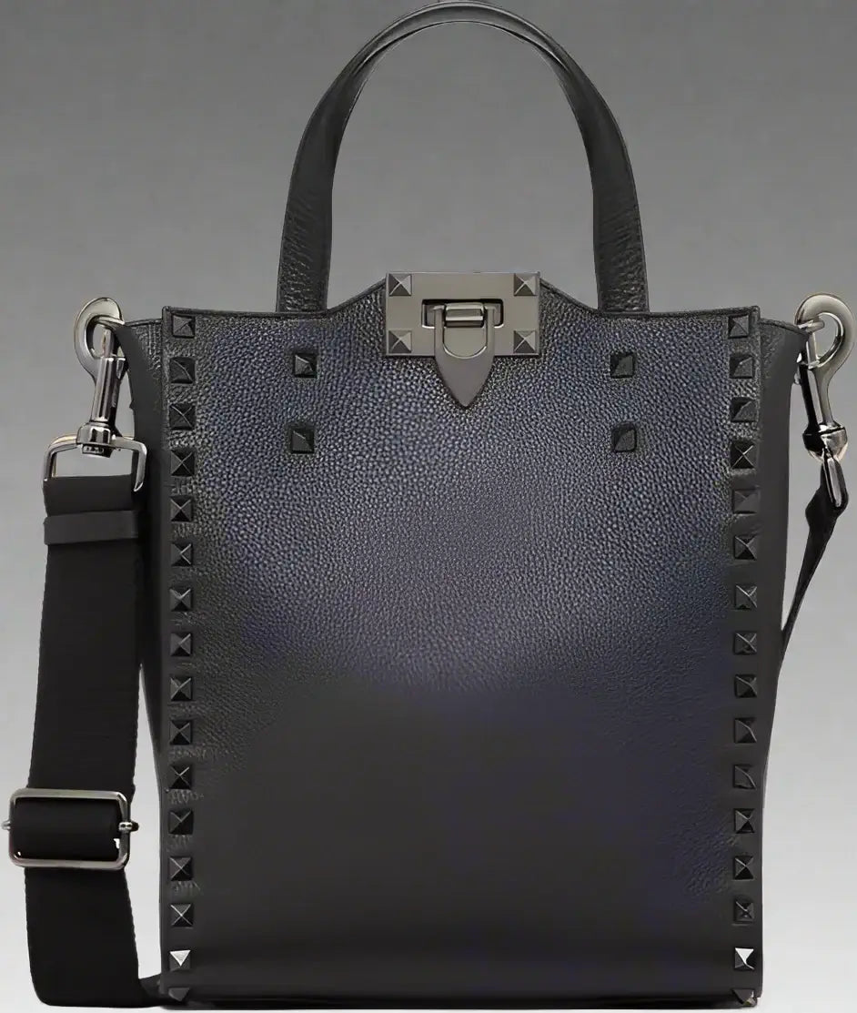 Black studded handbag with a shoulder strap on a white background