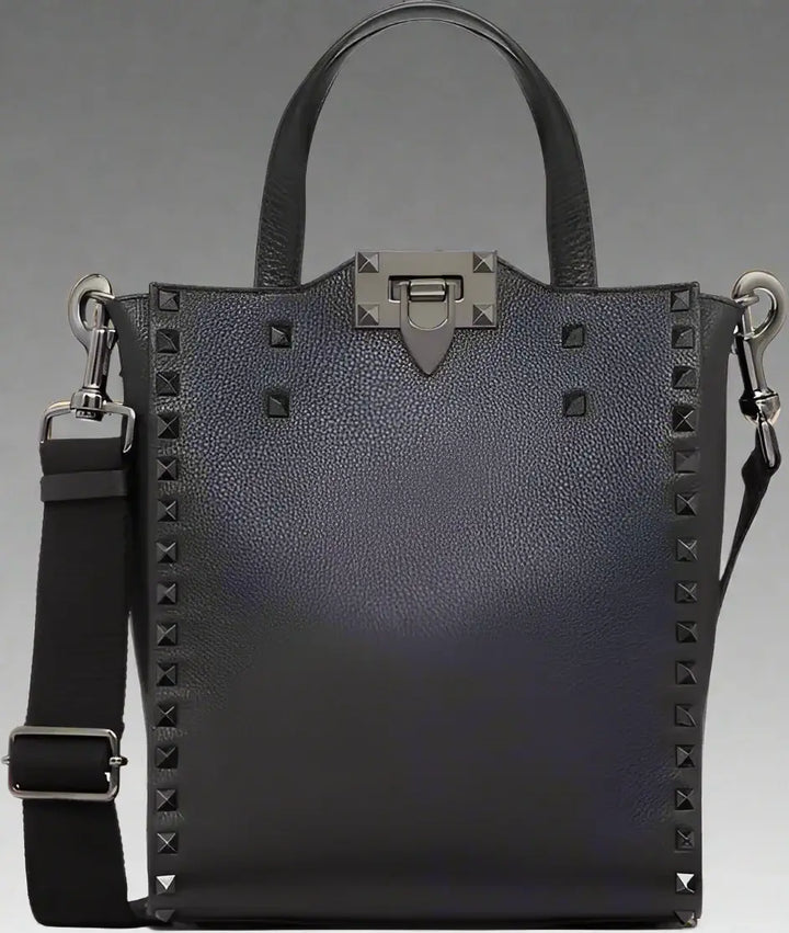 Black studded handbag with a shoulder strap on a white background