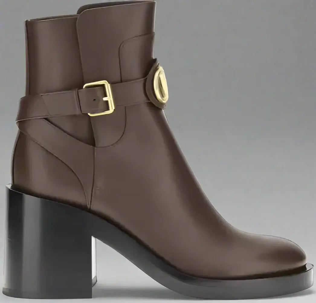 Brown ankle boot with gold buckle on a white background