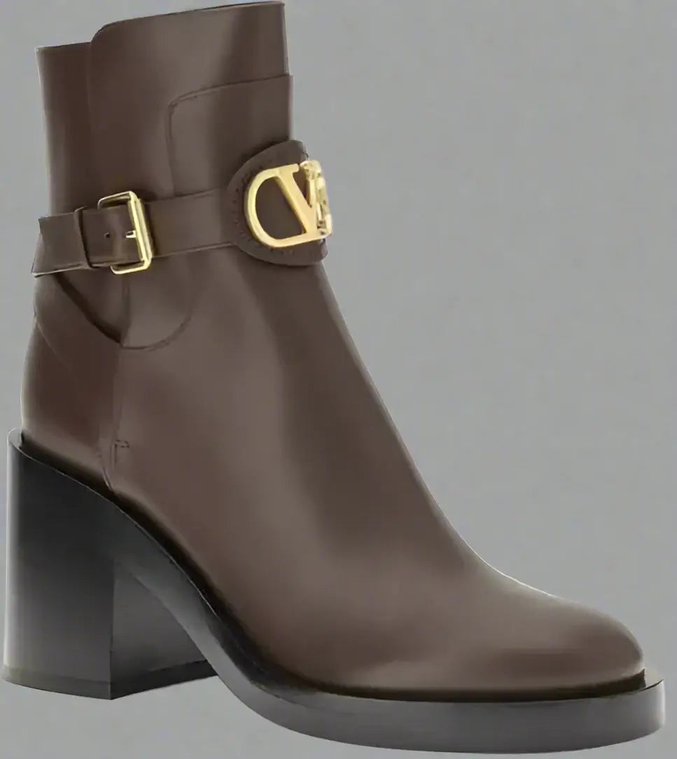 Brown ankle boot with gold buckle on a white background