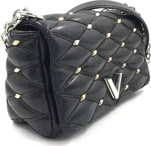 Black quilted handbag with gold studs and a visible brand logo on a white background