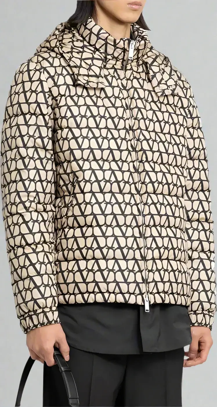 Person wearing a patterned jacket with geometric design on a neutral background