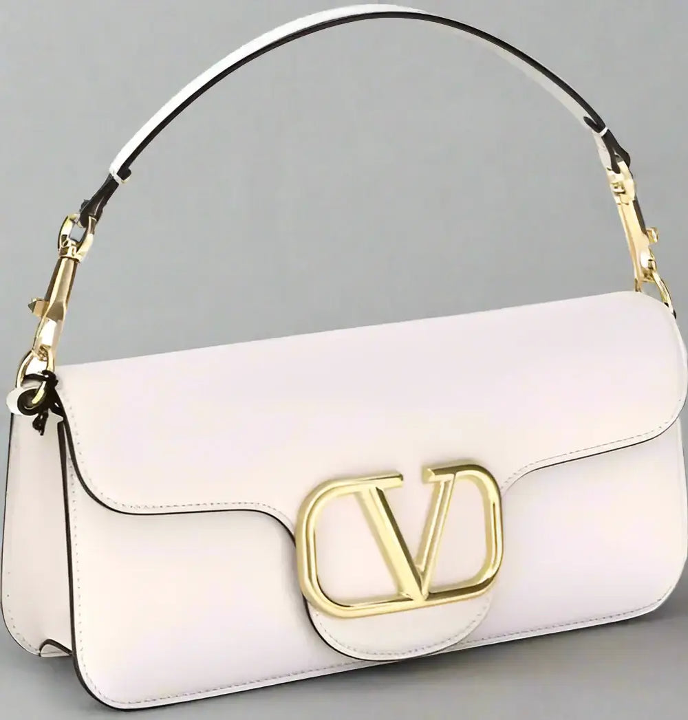 White handbag with gold logo on a white background