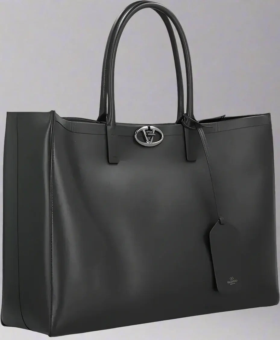 Black leather tote bag with a brand logo on a white background