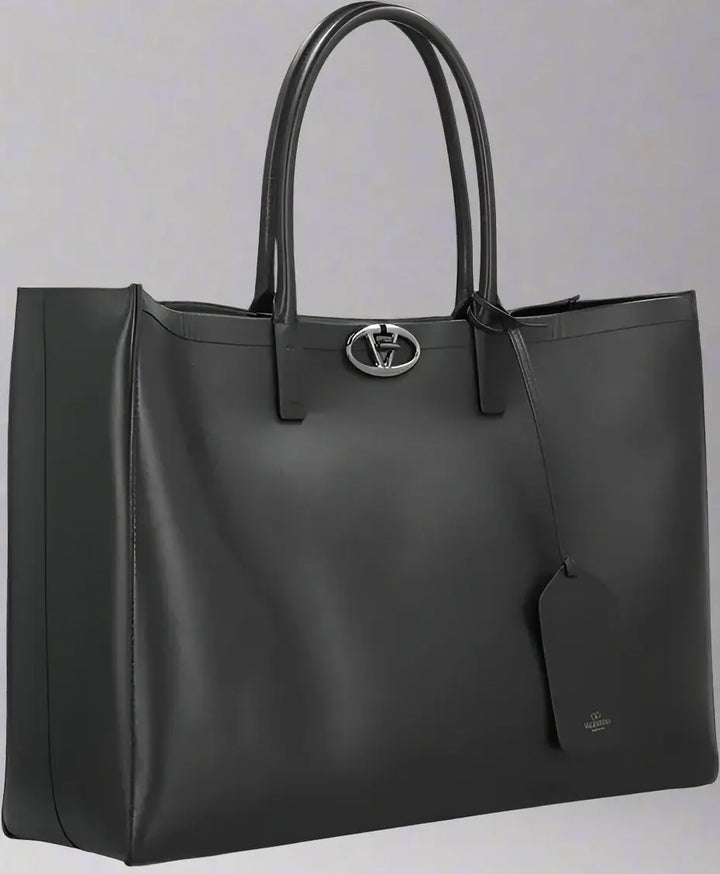 Black leather tote bag with a brand logo on a white background