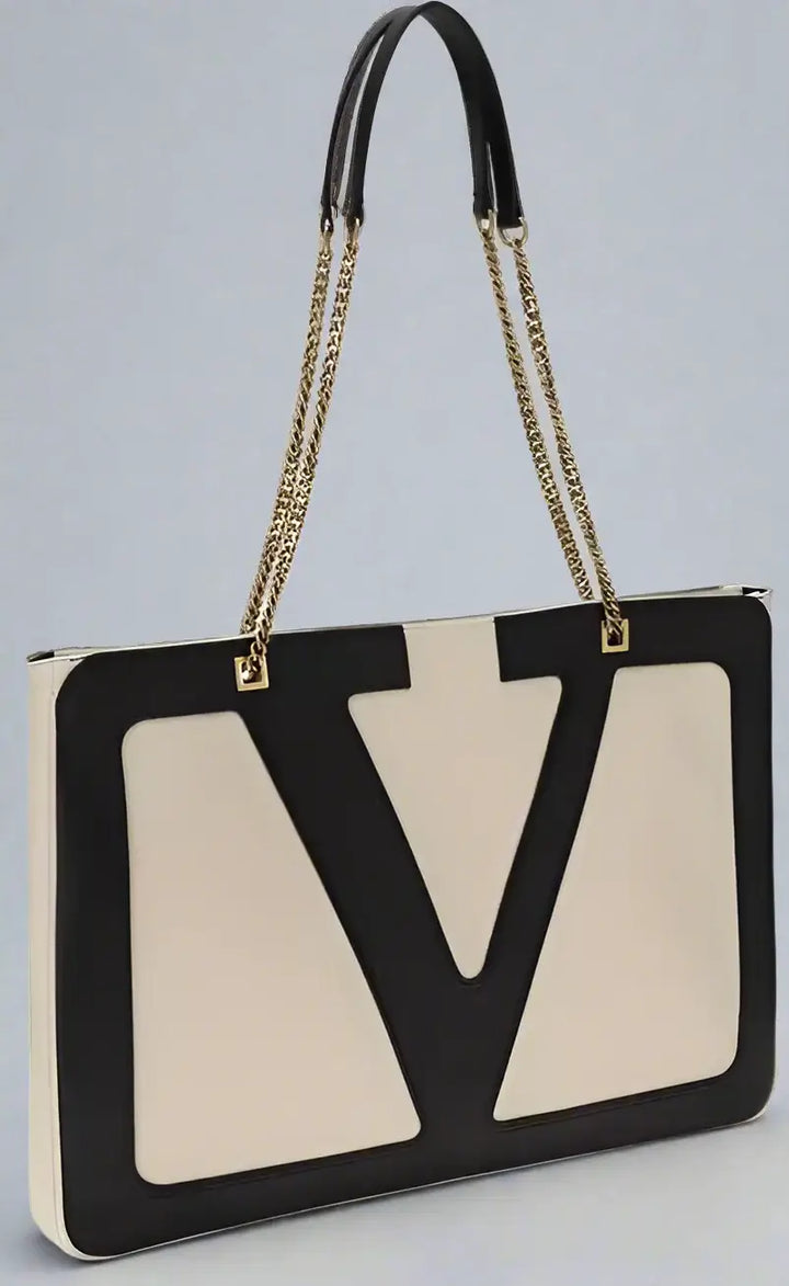 Designer handbag with a prominent logo on a white background