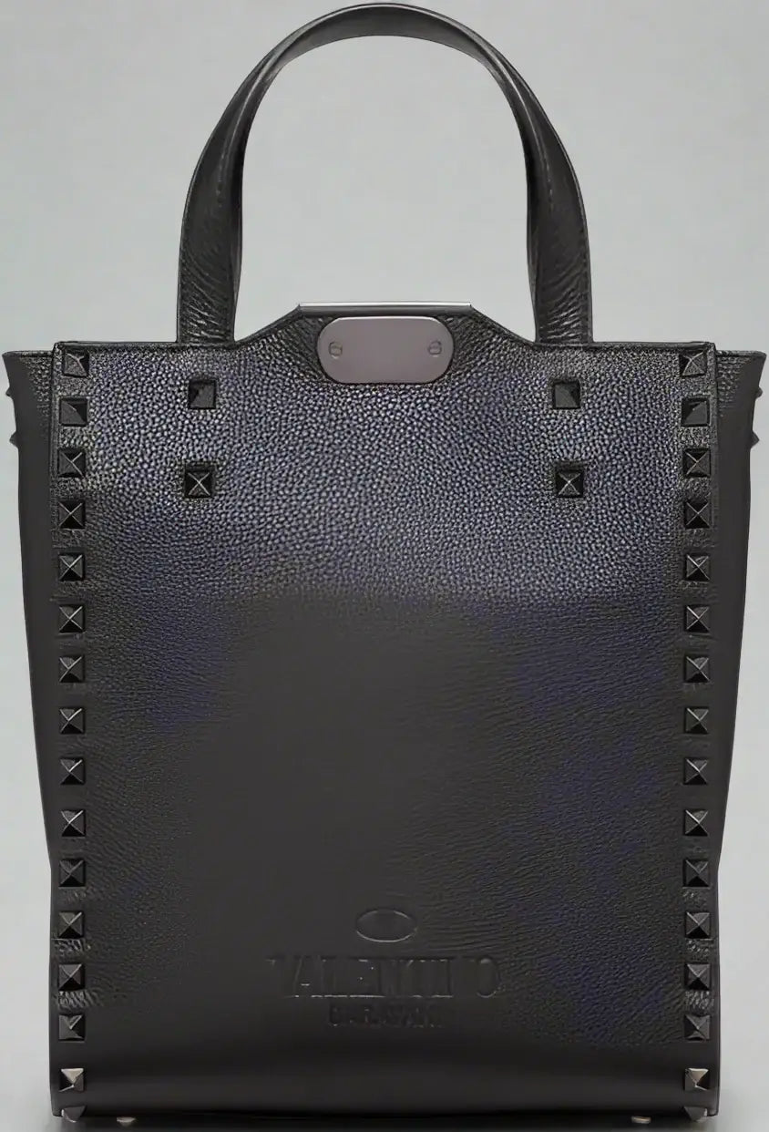 Black studded handbag with Valentino branding on a white background