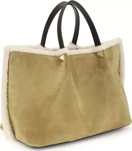 Beige tote bag with black handles on a white background