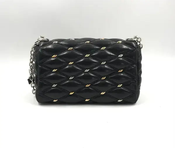 Black quilted handbag with gold studs on a white background