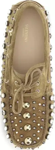 Beige suede shoe with gold studs on a white background