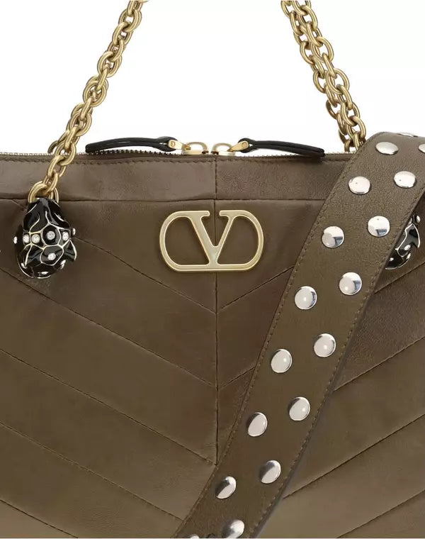 Brown handbag with gold chain strap and studded detail on a white background